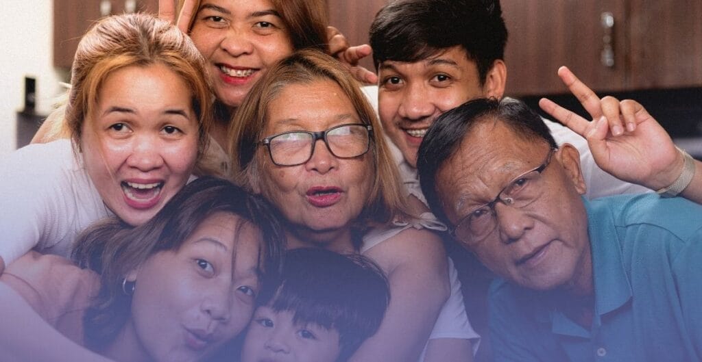 A multi-generational family smiling together, representing how age-related health topics like incontinence