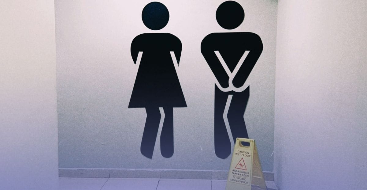 estroom symbols with a caution wet floor sign, representing when it is time to consider wearing an adult diaper for urine leaks.
